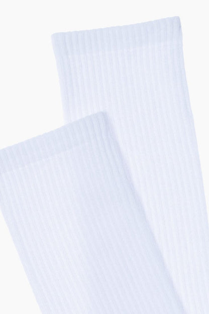 A pair of white ribbed crew socks shown partially overlapping against a plain white background.