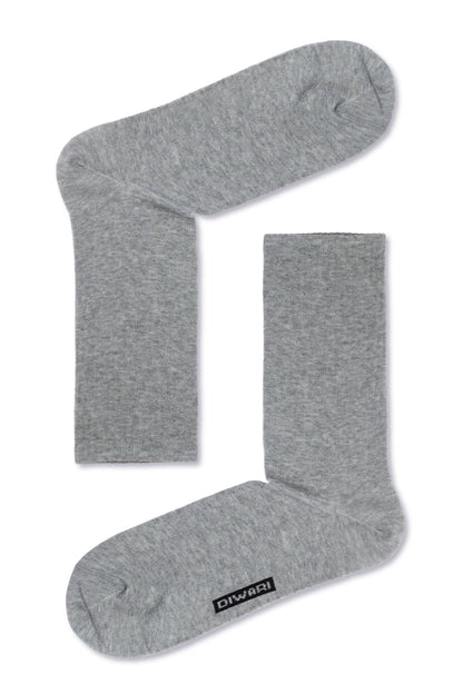 A pair of grey crew socks shown from a top-down perspective, with a small rectangular logo tag on the side of one sock.