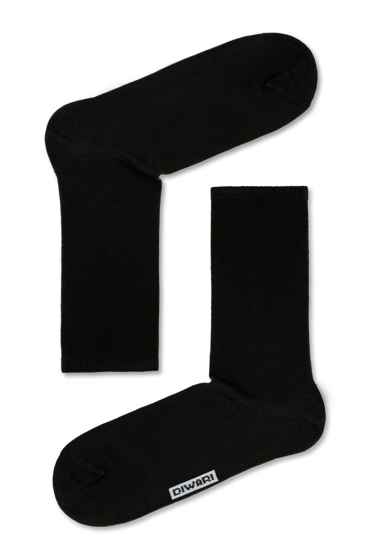 A pair of black crew-length socks featuring a small white rectangular logo patch on the side near the toe.