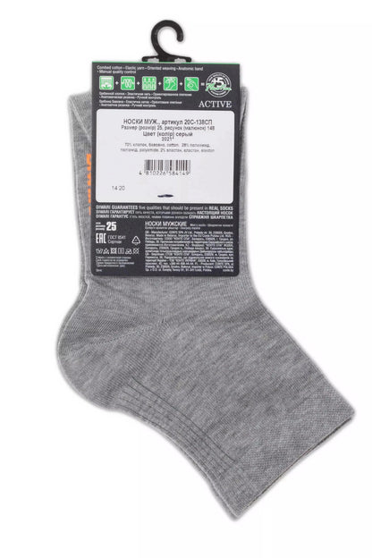 A pair of grey men's socks hangs from a plastic hanger, displaying a product tag with printed text and symbols on a white background.