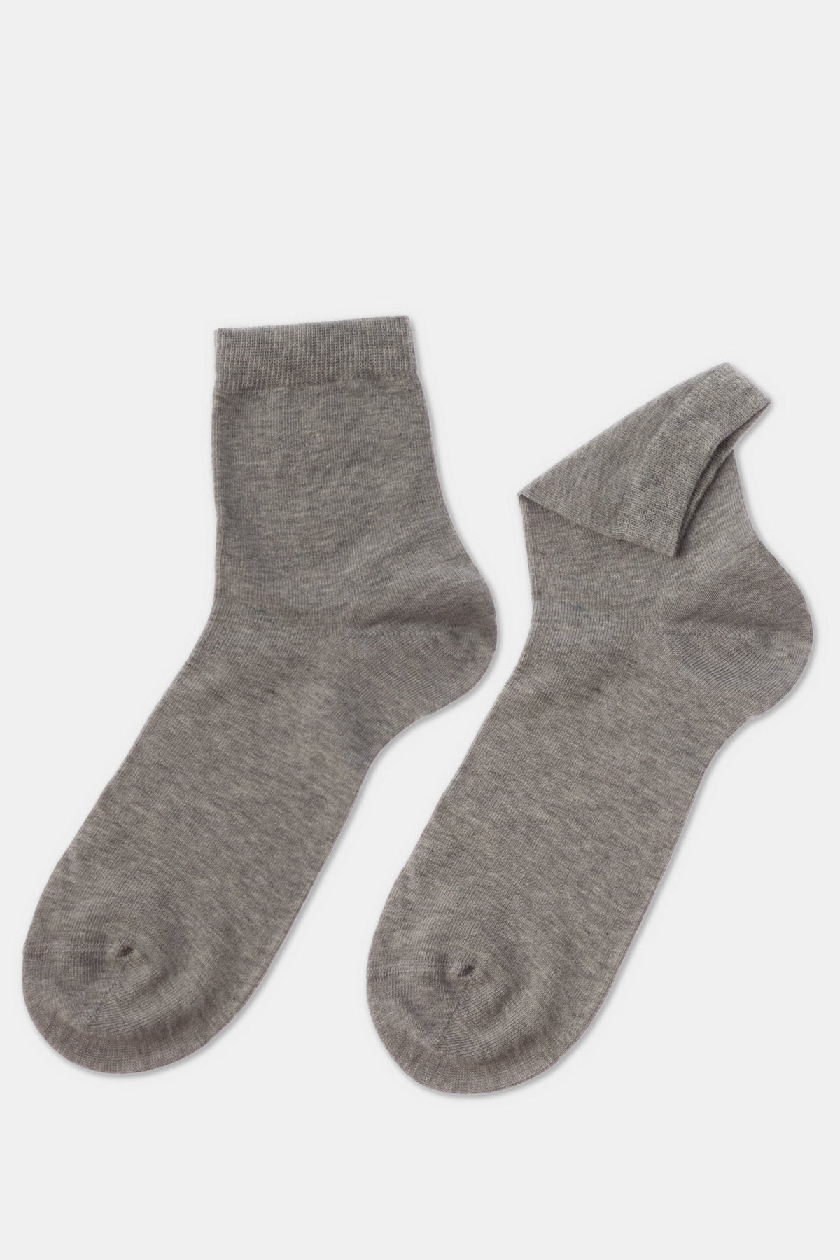 A pair of grey ankle socks laid flat on a light grey background.