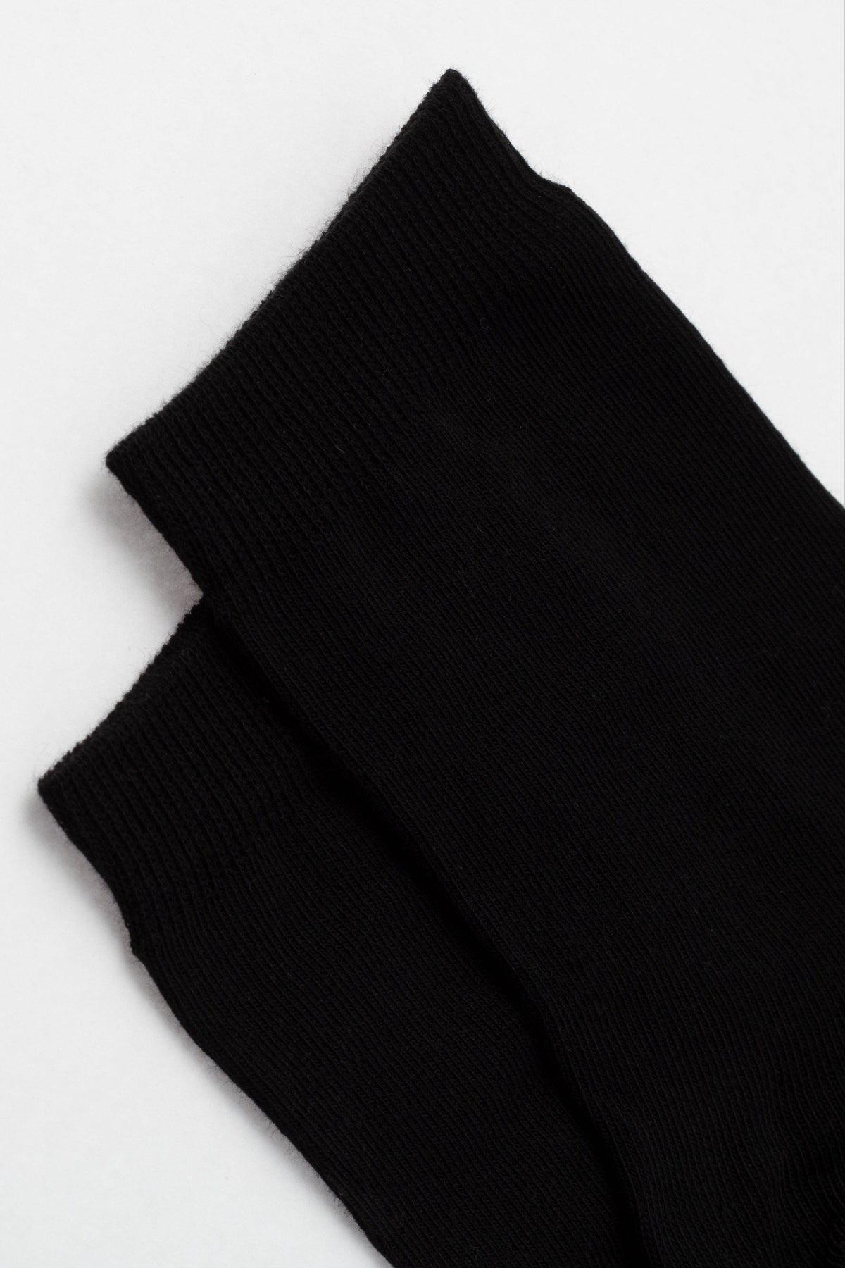 Two black socks shown from a top-down view against a plain light background.