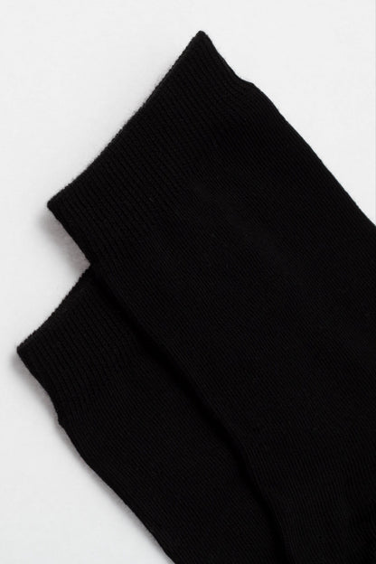 Two black socks shown from a top-down view against a plain light background.