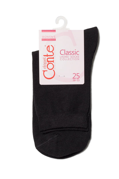 A pair of folded black socks on a white hanger with a product label featuring pink text and branding.