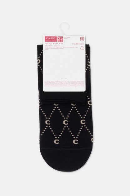 A pair of black women's socks featuring a repeating beige diamond pattern with the letter C inside each shape, displayed with a white informational label attached at the top.