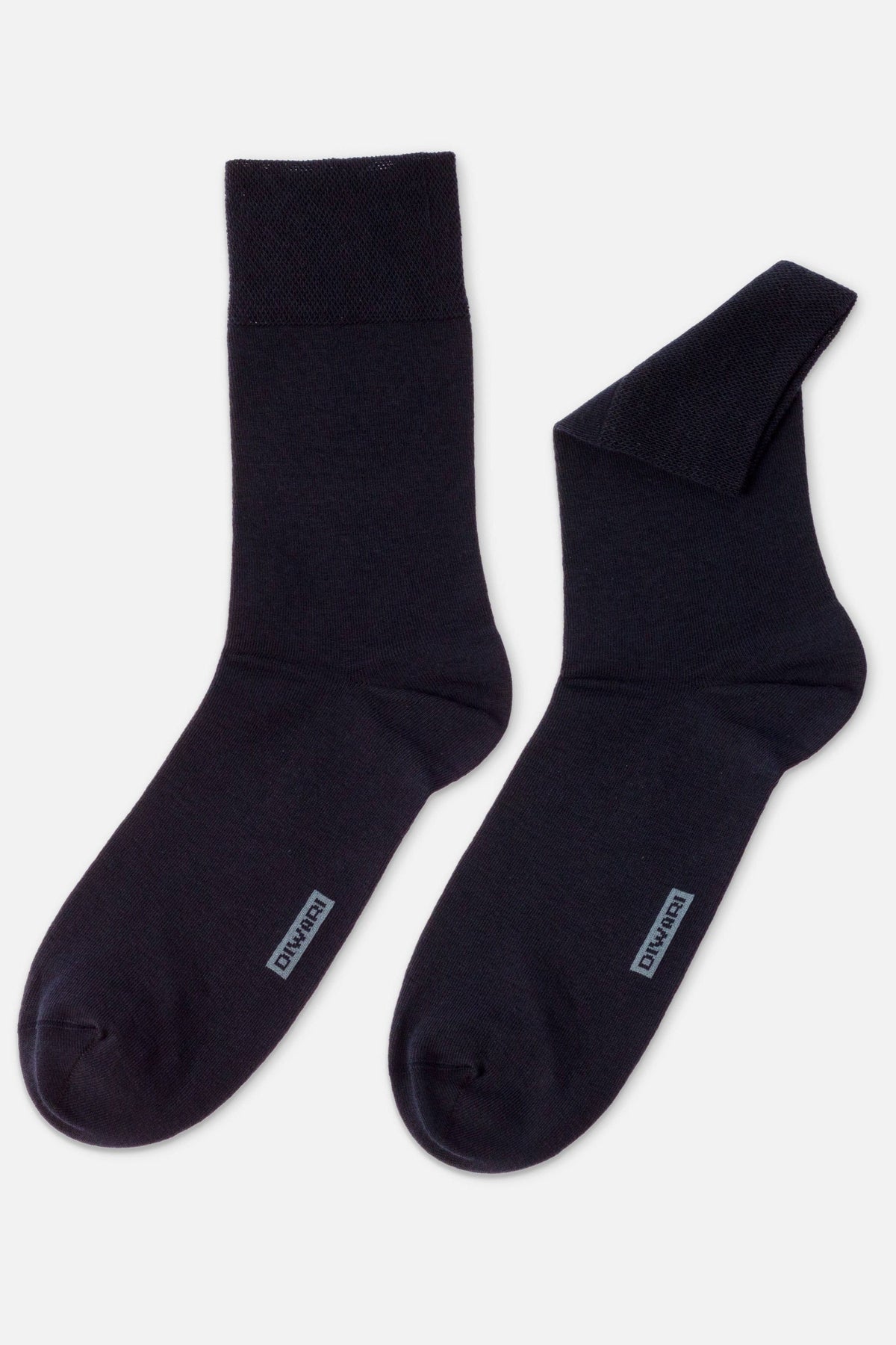 A pair of dark navy blue crew-length socks featuring a grey rectangular logo label on the top of the foot.