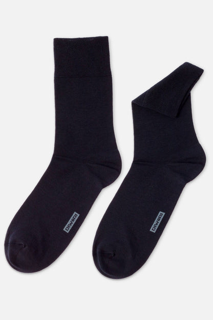 A pair of dark navy blue crew-length socks featuring a grey rectangular logo label on the top of the foot.