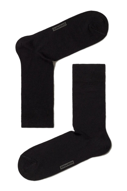 A pair of black crew-length socks laid out flat against a white background, featuring a subtle grey logo on the toe area of each sock.