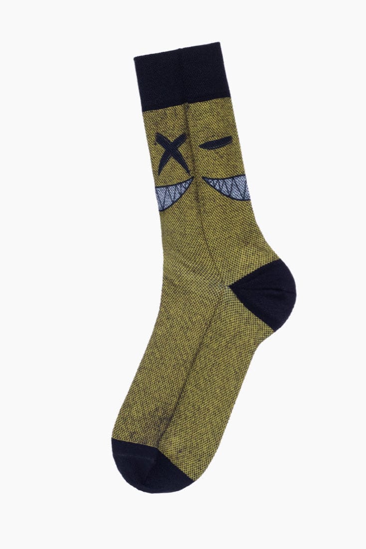 A crew length sock in a textured olive green fabric featuring a black heel, toe, and cuff, with a graphic of an x-shaped eye and a winking eye above a grinning mouth with sharp teeth.