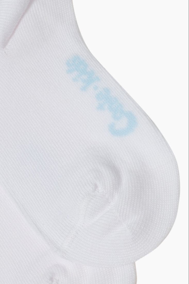 A close-up of a white sock featuring a soft blue logo printed near the heel.