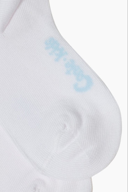 A close-up of a white sock featuring a soft blue logo printed near the heel.