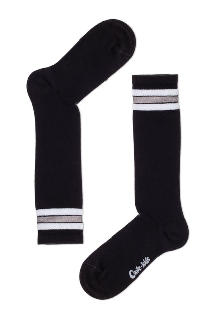 A pair of black crew-length socks featuring two white horizontal stripes and a shimmering metallic silver accent line near the cuffs.