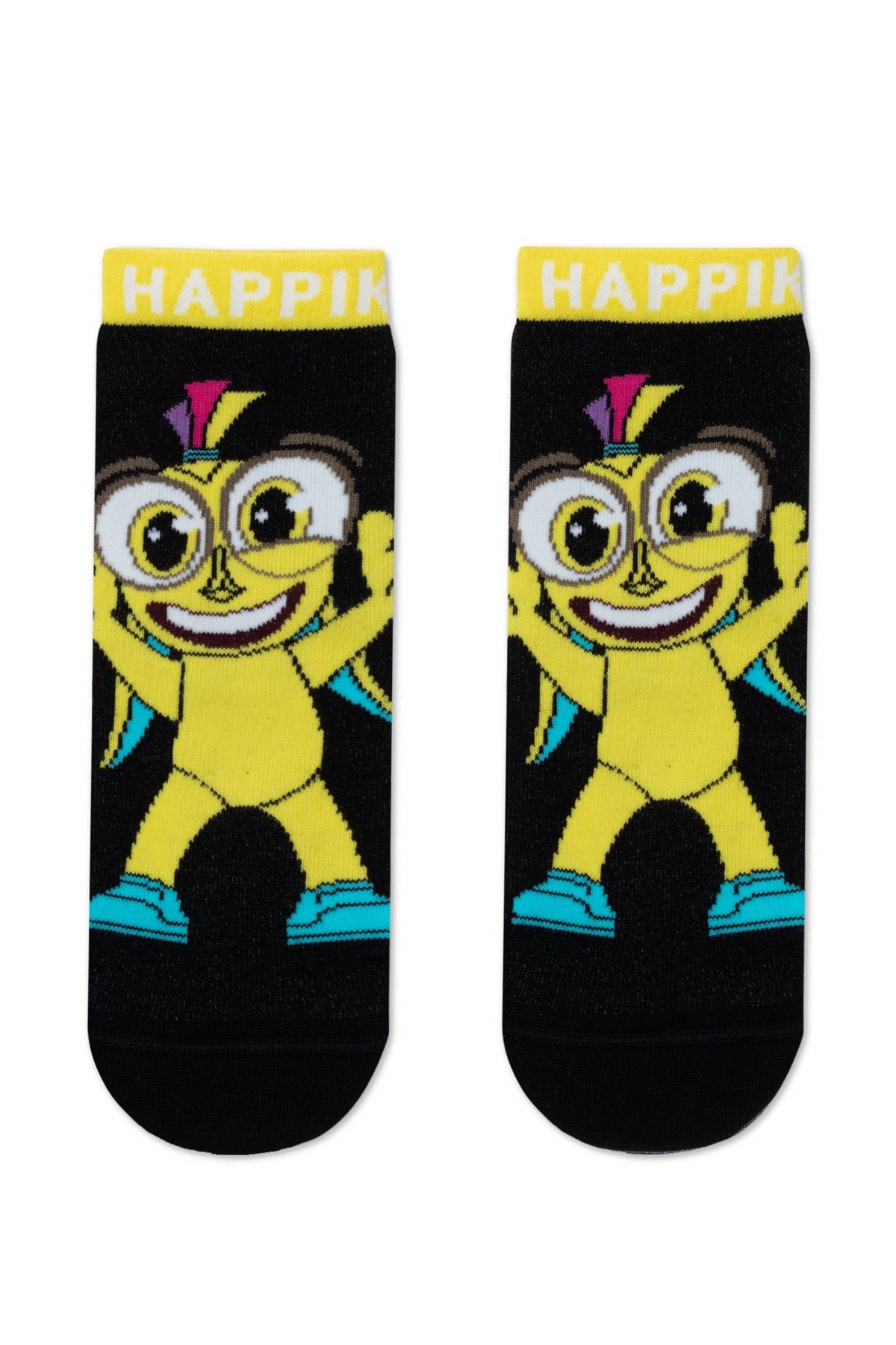 A pair of black ankle socks feature a cartoon yellow character with large eyes, a wide smile, and a purple and pink mohawk, with the word HAPPiK printed in white on the yellow top trim.
