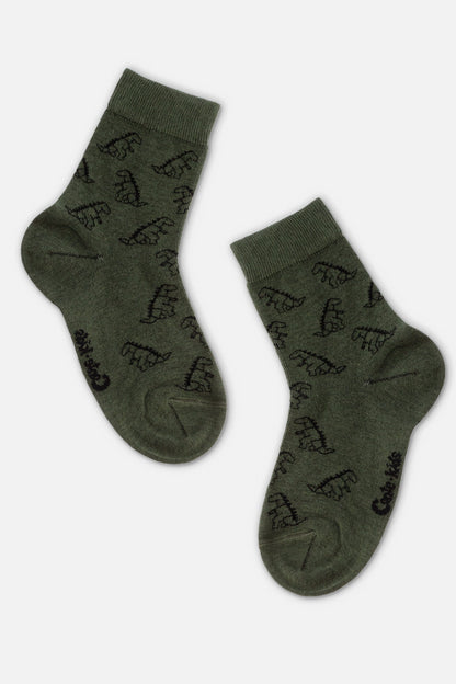 A pair of olive green crew socks decorated with a repeating pattern of small black dinosaur silhouettes.
