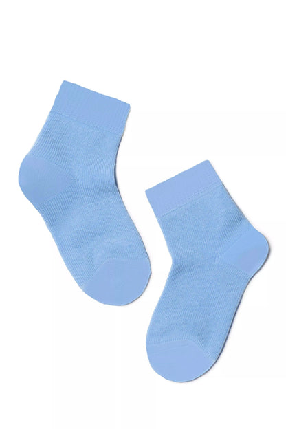 A pair of light blue ankle-length socks positioned diagonally against a plain white background.