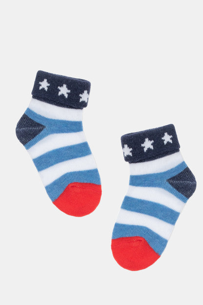 A pair of infant socks featuring blue and white horizontal stripes, dark blue cuffs with white stars, and bright red toes.