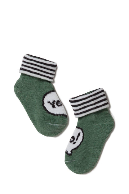 A pair of green infant socks with black and white striped cuffs, each featuring a white speech bubble graphic containing black text.
