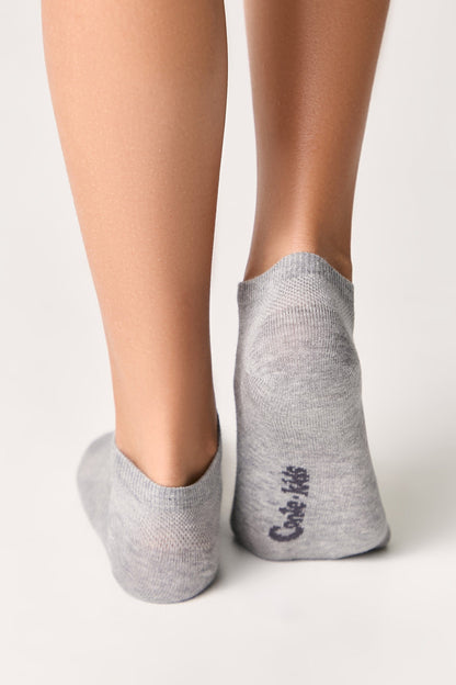 Low-cut ankle socks in light grey worn on a person's feet against a plain white background.