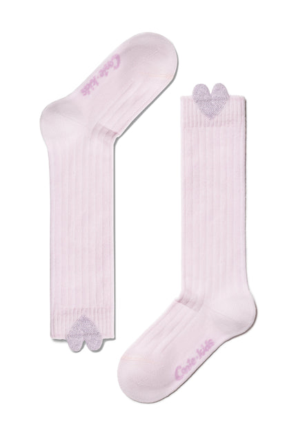A pair of light pink ribbed socks featuring a small, glittery silver heart detail at the top cuff and branded text on the sole.