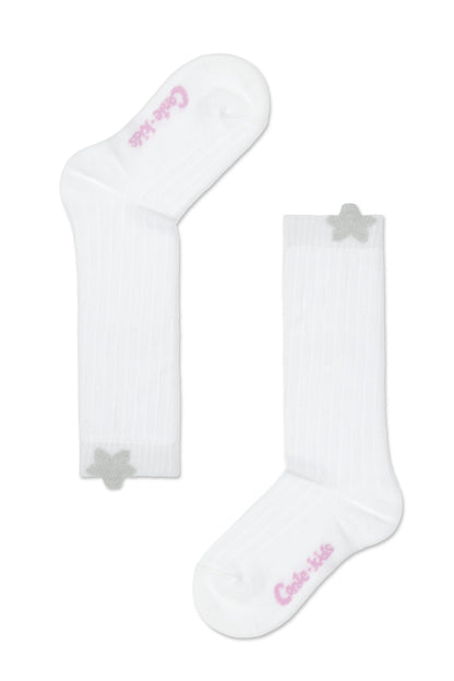 A pair of white ribbed socks featuring a small silver glittery star accent near the top cuff and pink branded text on the sole.