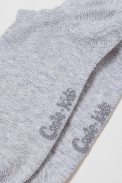 A pair of grey marl ankle socks featuring the words Cute Kids printed in a darker grey textured font on the side.