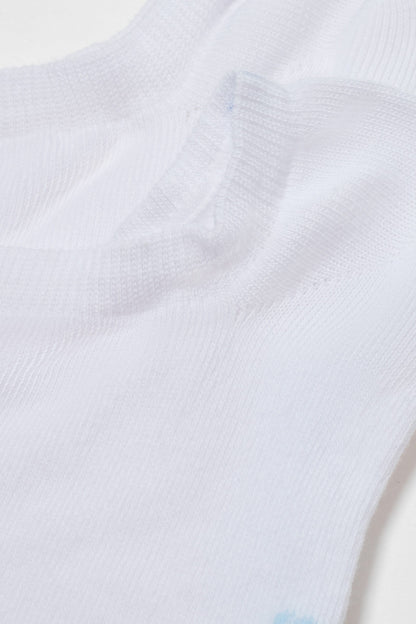 A close-up of a white sock showing the textured knit fabric and the ribbed elastic cuff.