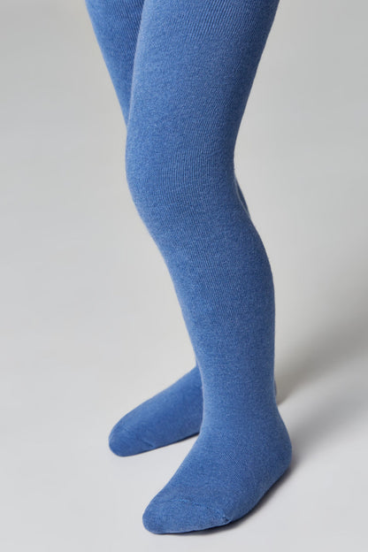 A pair of blue tights worn on a child's legs against a plain light gray background.