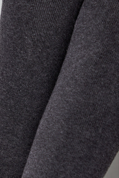 Close-up of charcoal gray fabric showing the textured knit pattern with visible vertical ribbing.