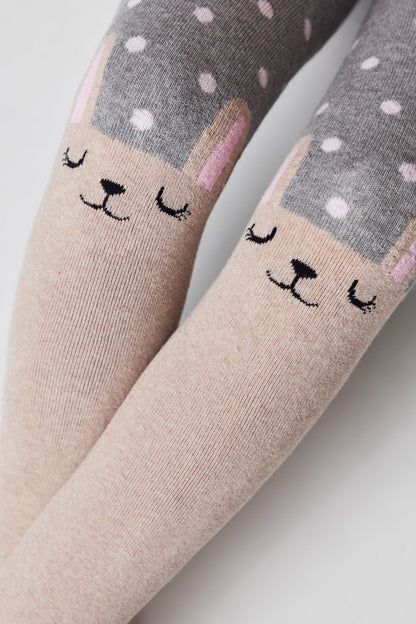 Children's tights featuring a beige rabbit face design on the knees with a grey and white polka dot pattern on the thighs.