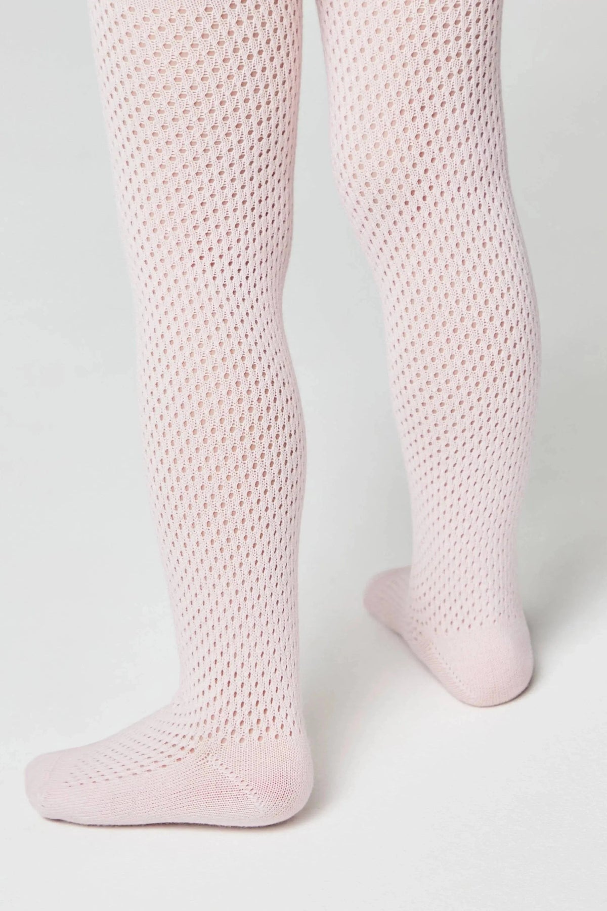 Pale pink knit tights featuring a delicate, repetitive open-work diamond pattern on the legs and solid knit fabric at the feet.