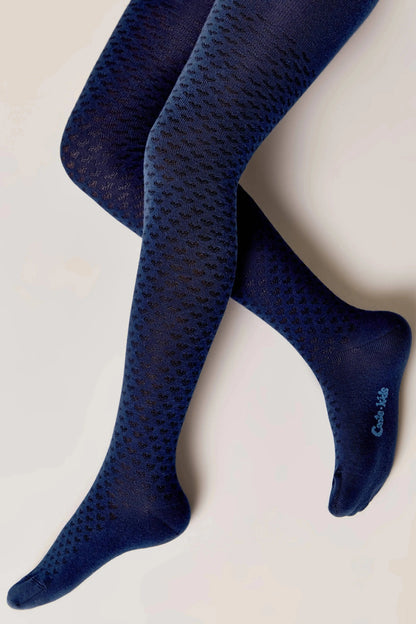 A pair of navy blue patterned tights with a small, repeated heart-shaped texture, displayed on a plain white background.