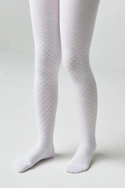 White patterned tights with a textured micro-heart print worn on a child's legs against a solid light gray background.