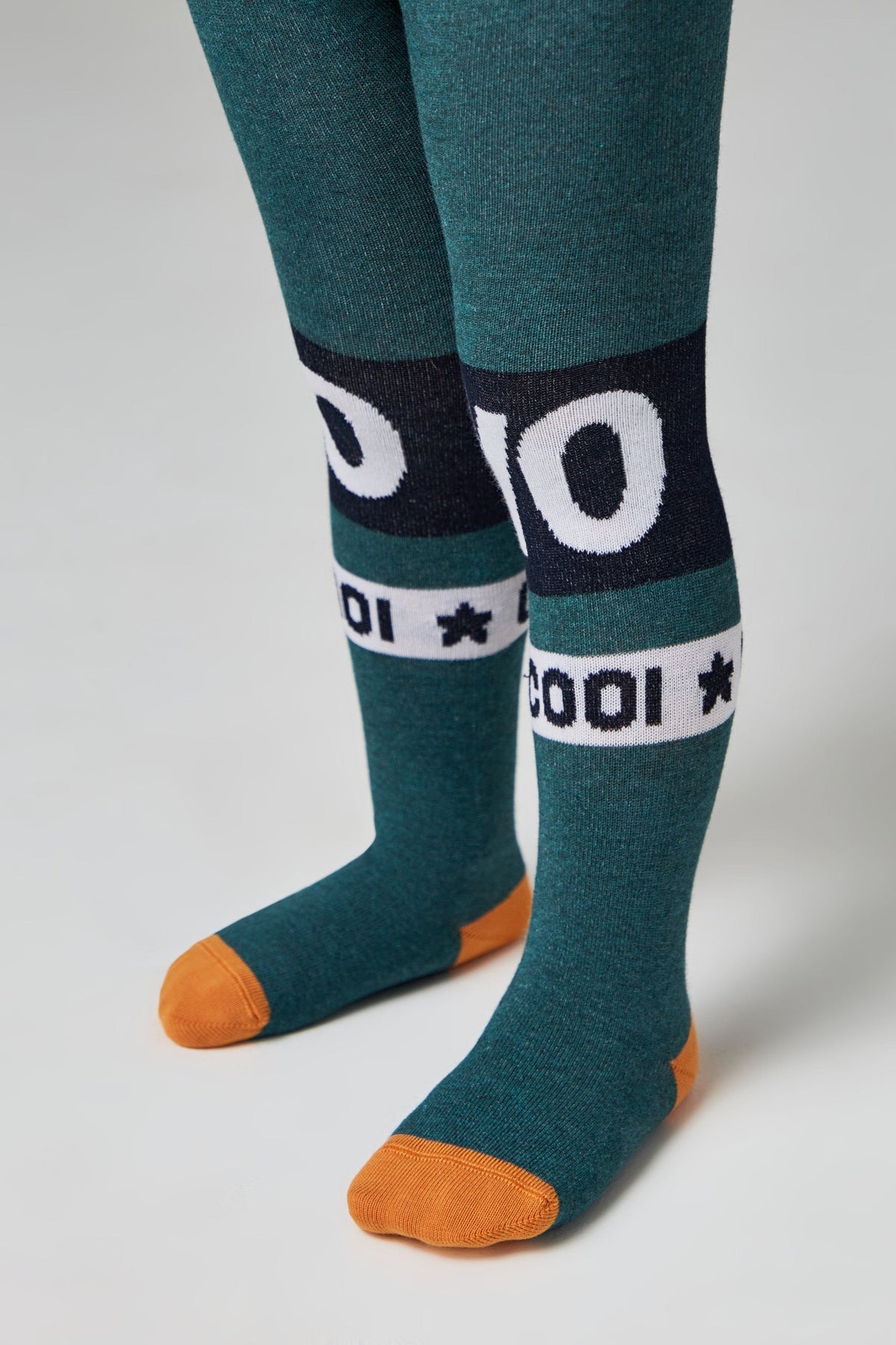Pair of teal tights with orange toes and heels, featuring navy blue bands at the knees with white lettering that reads 10 and COOL along with star icons.