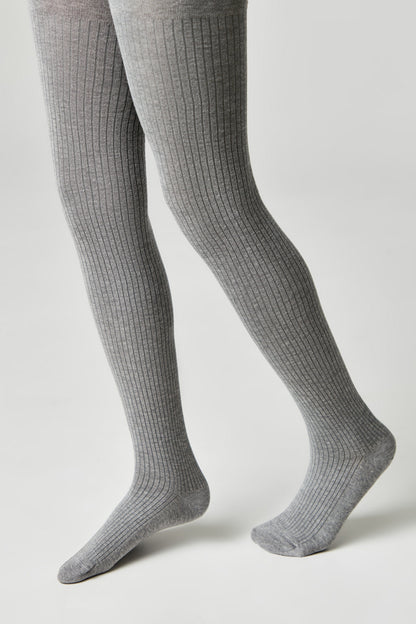 Gray ribbed tights worn on a person's legs against a solid light gray background.