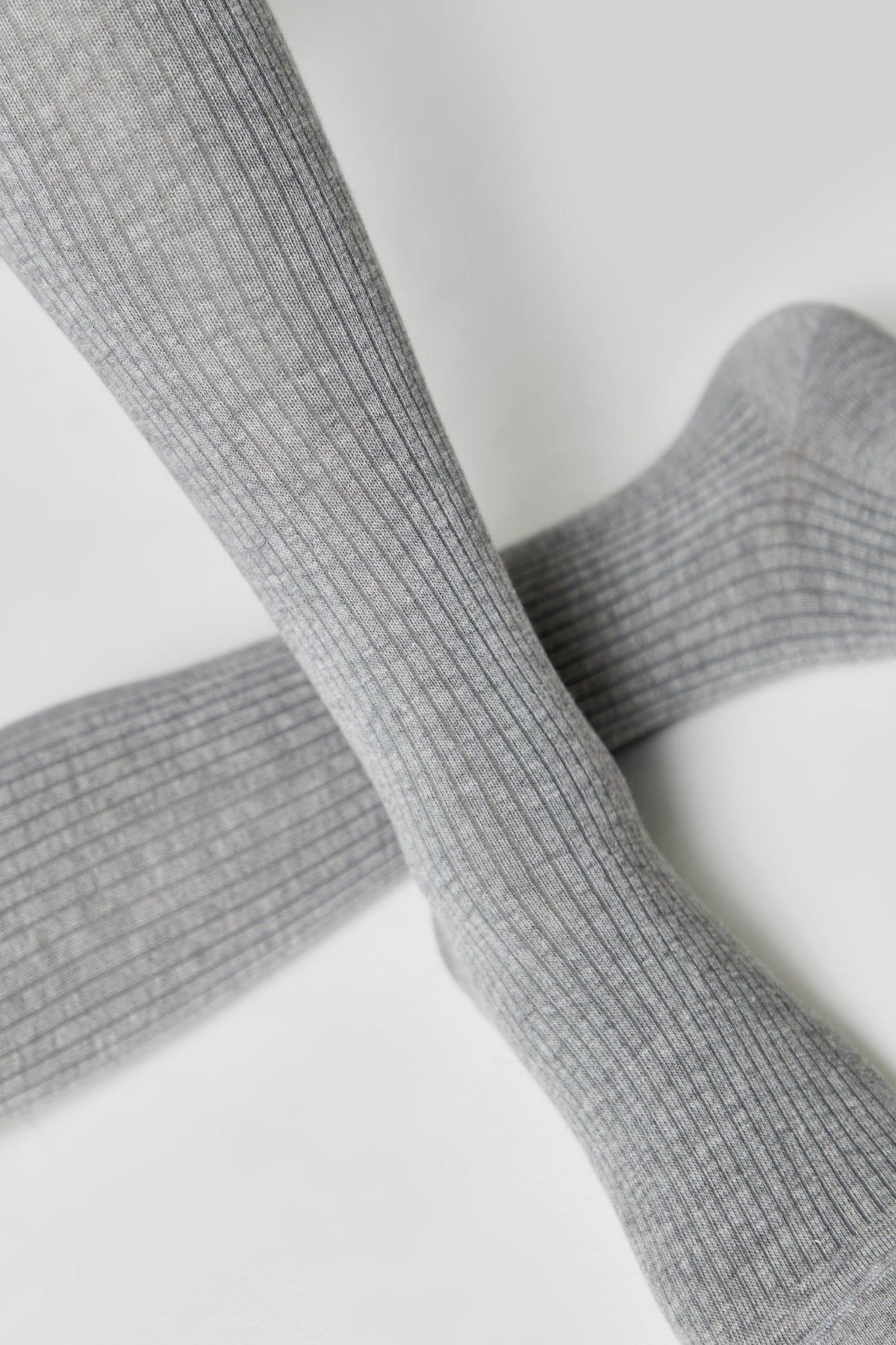 A pair of grey ribbed socks shown against a plain white background.