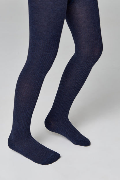 A pair of ribbed dark blue tights are worn on the legs against a plain light gray background.
