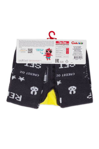 Dark grey children's tights with white star and abstract patterns feature a yellow gusset and a cardboard packaging tag attached at the top.