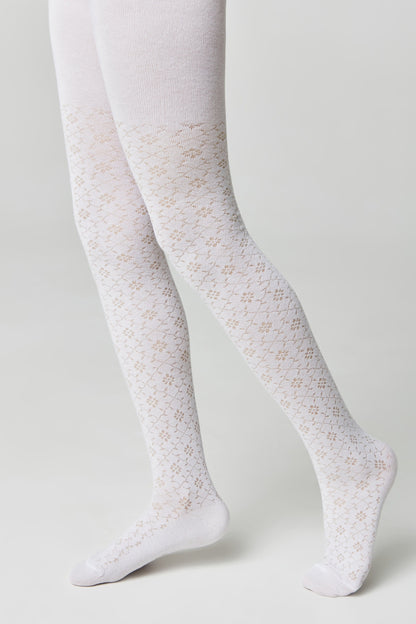 A pair of white tights featuring a delicate floral lace pattern throughout the legs, worn by a person against a plain light gray background.