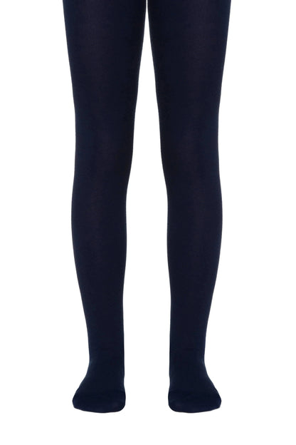 A pair of opaque navy blue tights worn on legs against a white background.