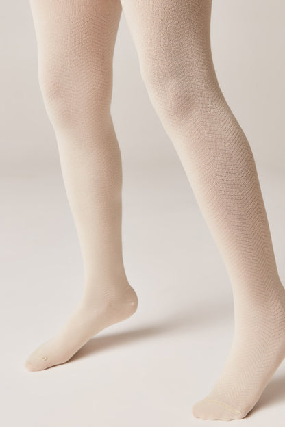 Beige textured tights worn on a pair of legs against a plain light-colored background.