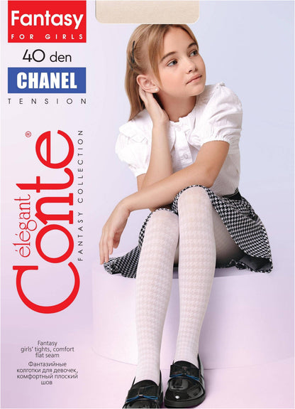A young girl with blonde hair sits wearing white patterned tights, a white short-sleeved blouse, and a black and white houndstooth skirt.