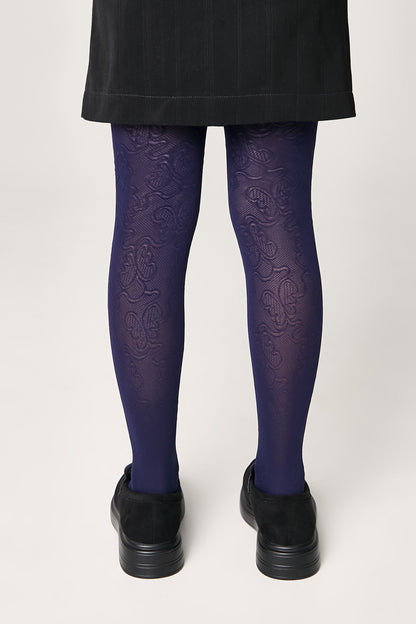 Dark purple patterned tights worn with a black skirt and black shoes against a plain white background.