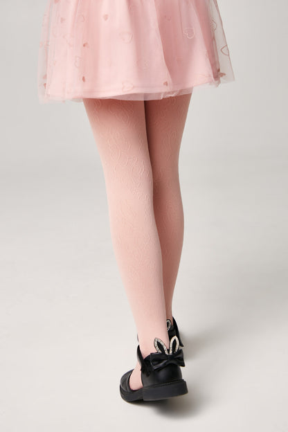 A pair of light pink patterned tights worn with a pink heart-patterned tulle skirt and black shoes featuring decorative rabbit ears on the heels.