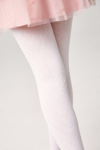 White textured tights with an intricate floral paisley pattern are worn under a pale pink pleated skirt.