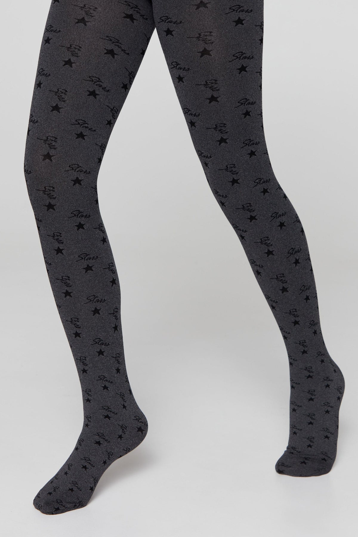 Patterned tights in dark grey featuring a repeating design of black stars and the word "Stars" in a cursive font.