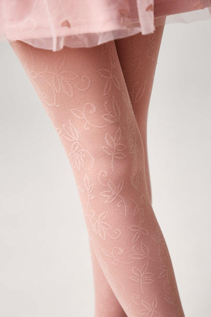 Pink patterned tights with a delicate floral lace design worn with a matching light pink skirt.