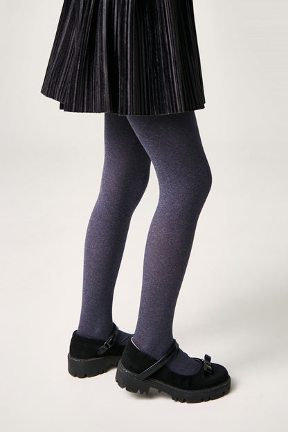 A pair of dark grey opaque tights worn with a pleated black skirt and black buckled Mary Jane shoes.