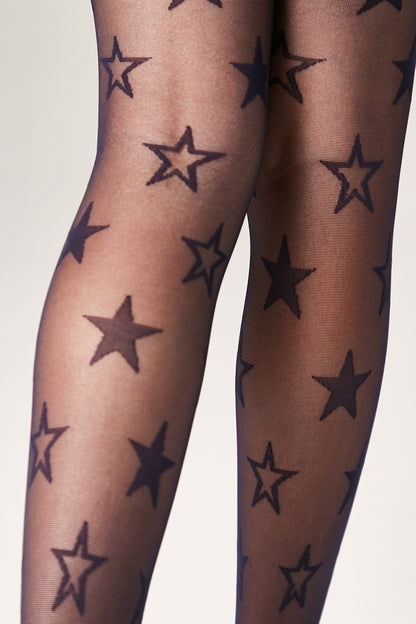 Sheer black tights patterned with solid black star shapes worn on legs against a plain background.