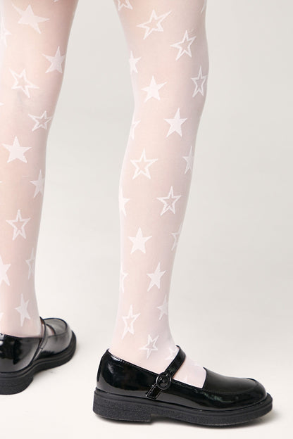 White tights featuring a recurring white star pattern worn with black patent leather Mary Jane shoes against a light grey background.