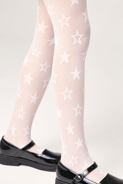 White tights featuring an all-over pattern of white stars are worn with black patent leather Mary Jane shoes.